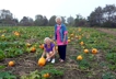 Choosing a pumpkin in the pumpkin patch at Sweet Berry Farm